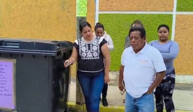 Vecinos limpian sus contenedores de basura